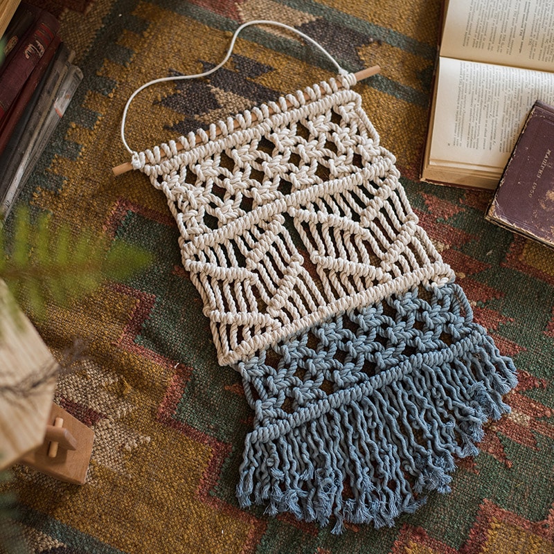 Handmade blue knotted wall tapestry featuring cotton rope and wooden stick, perfect for home decor.