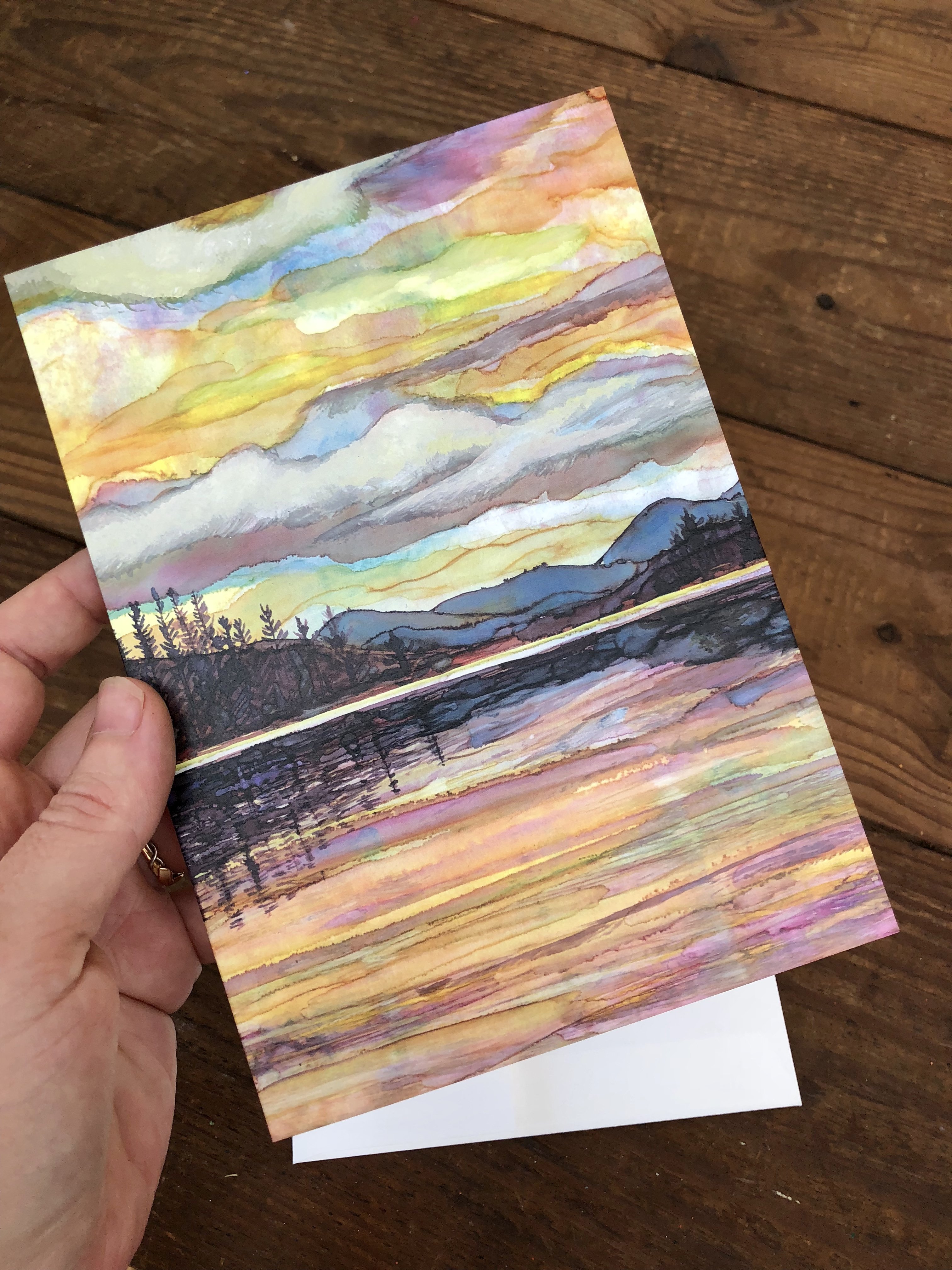 Lake Sunset Greeting Card featuring dual landscape paintings on the cover and inside, printed on heavyweight matte paper.