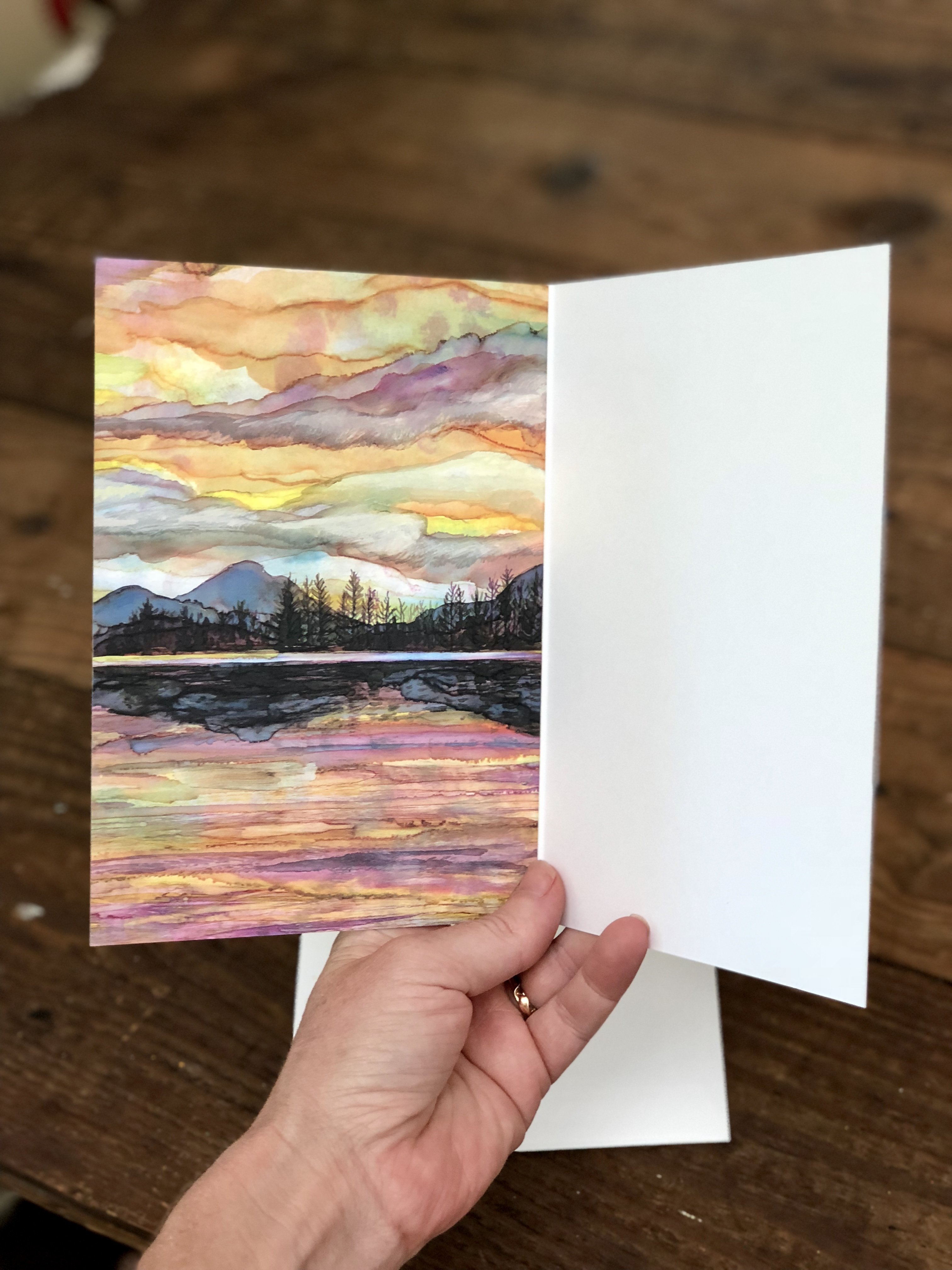 Lake Sunset Greeting Card featuring dual landscape paintings on the cover and inside, printed on heavyweight matte paper.