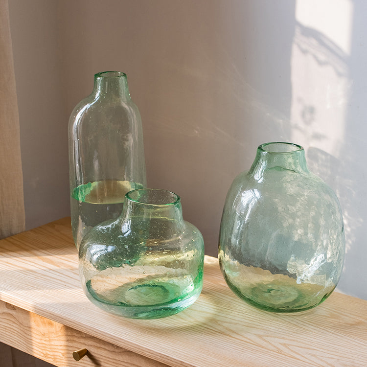 Large Artisan Glass Irregular Shape Vase in clear and green colors, showcasing its unique hand-blown design and elegant curves.