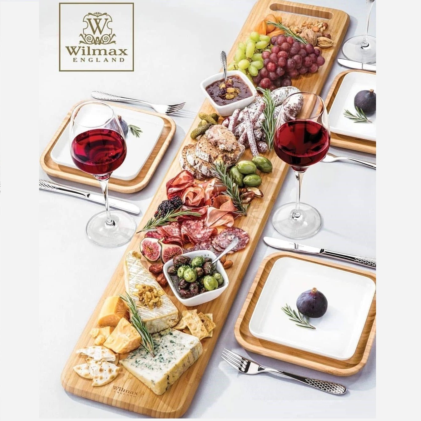 Large Feast Charcuterie Plating Set featuring a long bamboo serving tray and assorted porcelain plates and bamboo platters, ideal for entertaining.