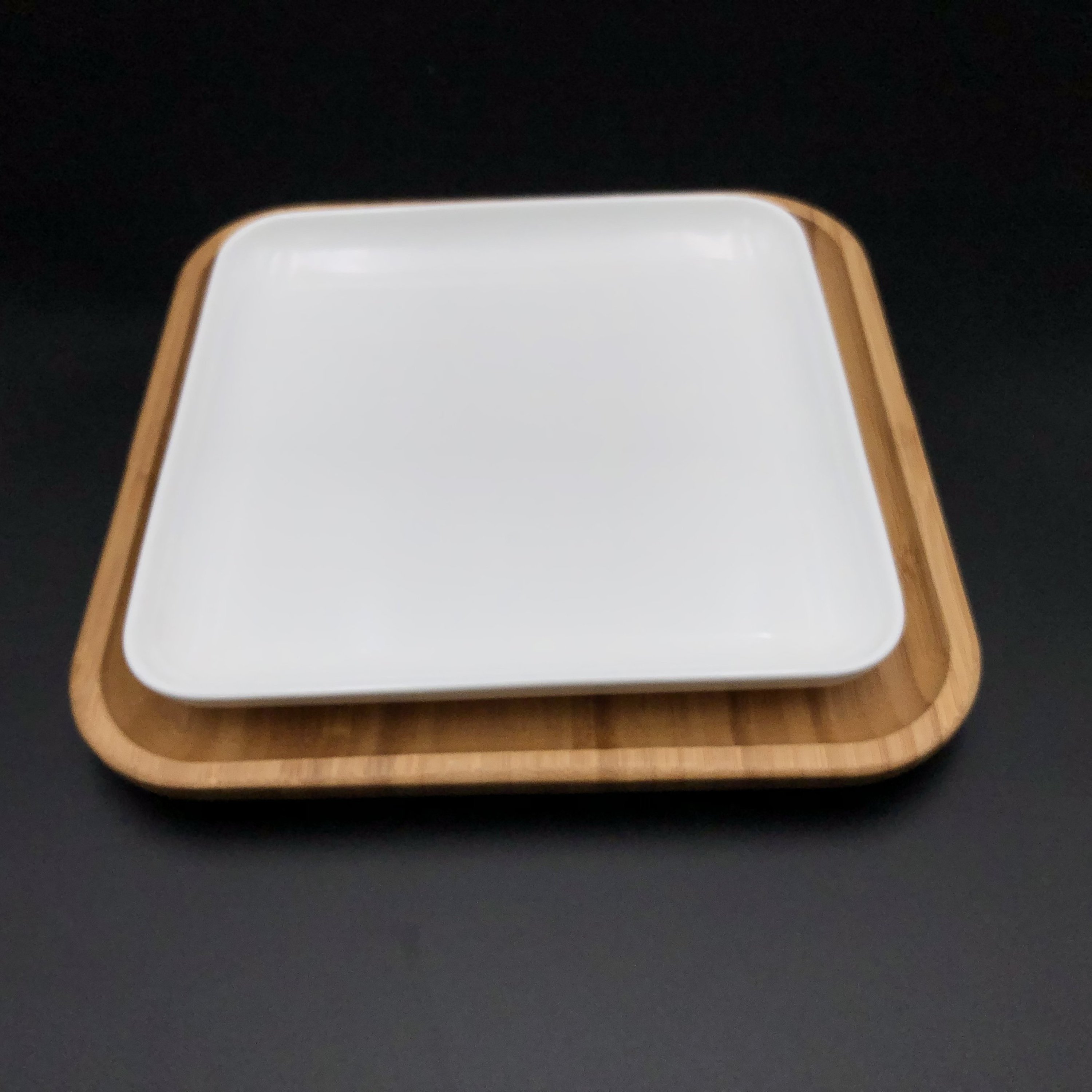 Large Feast Charcuterie Plating Set featuring a long bamboo serving tray and assorted porcelain plates and bamboo platters, ideal for entertaining.