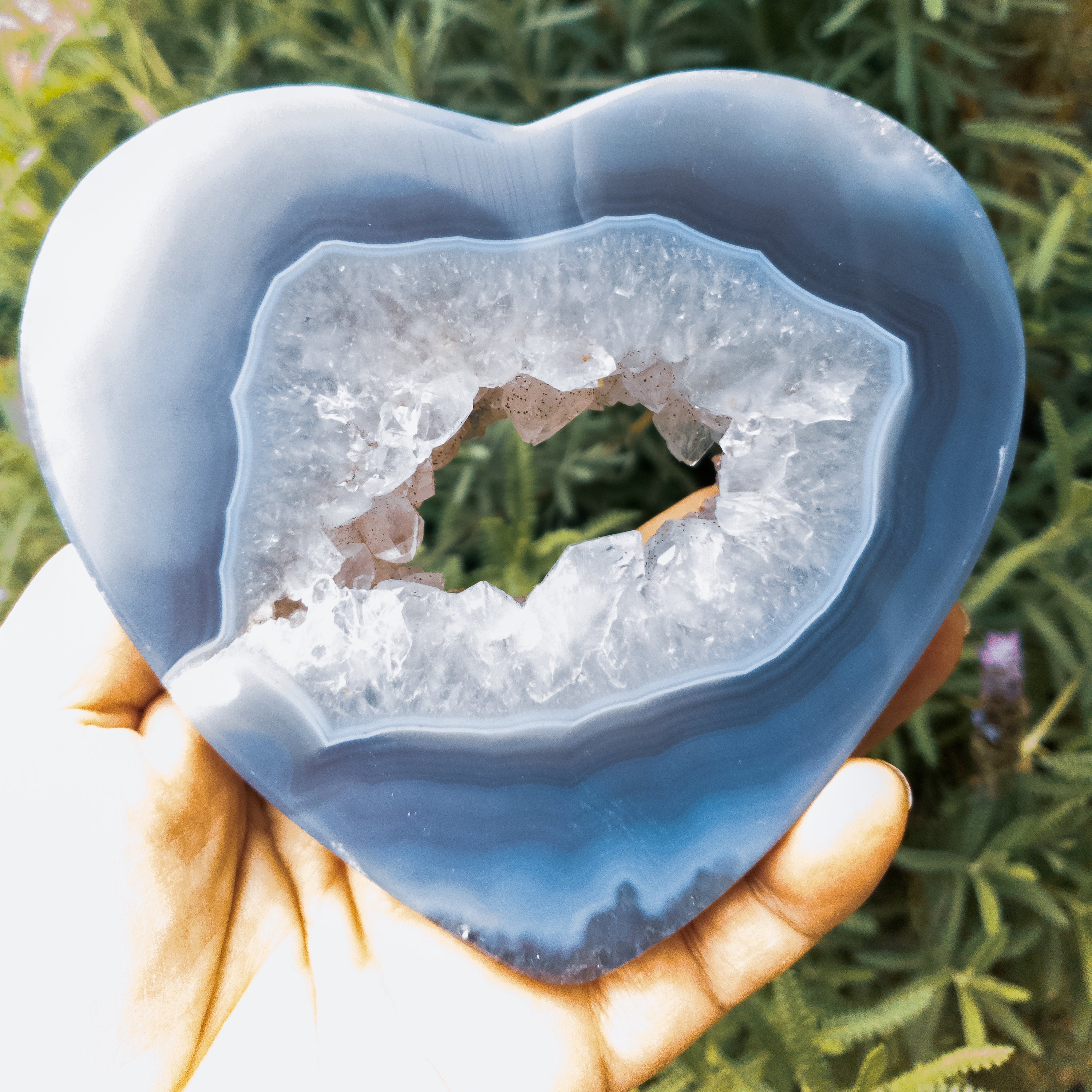 A large heart-shaped agate stone, showcasing vibrant colors and unique patterns, handcrafted by Brazilian artisans.