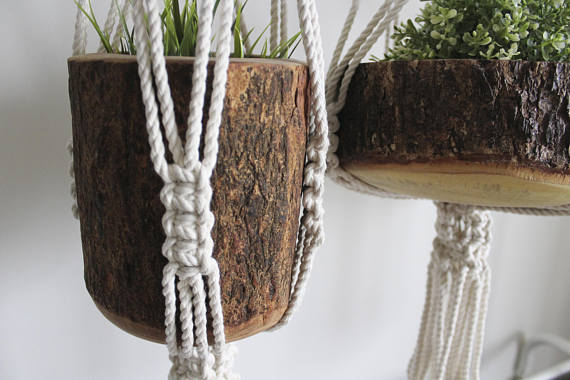 Large macrame plant hanger made of 100% cotton rope, featuring intricate knots and tassels, designed to hold pots up to 12 inches in diameter.