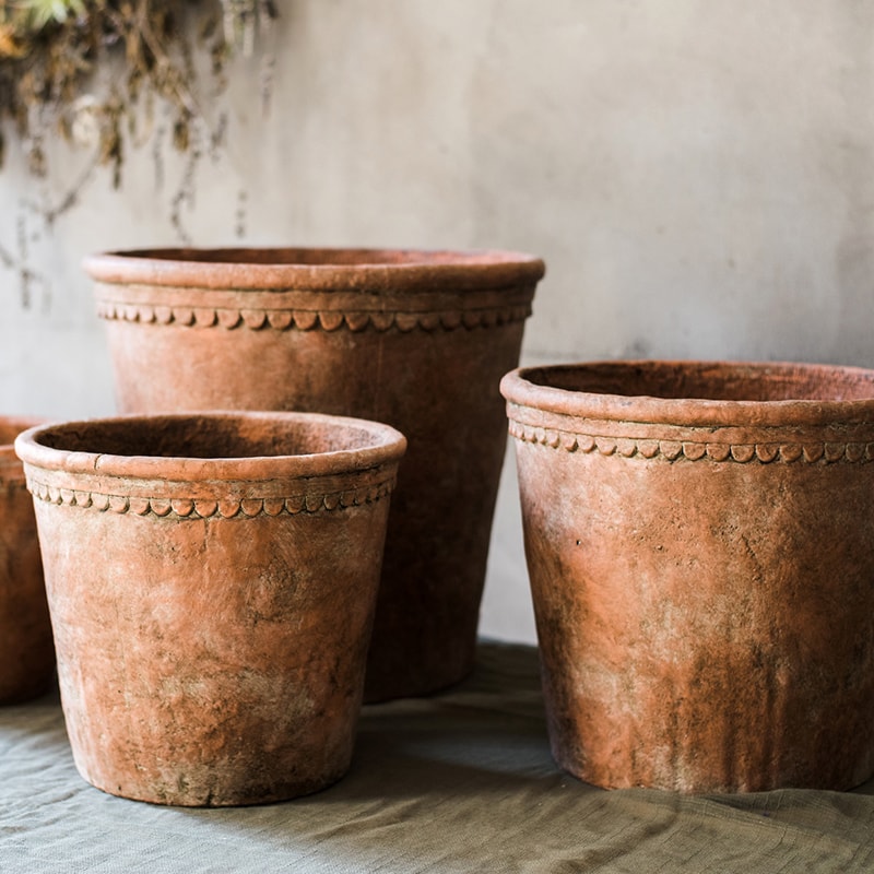 Large terracotta red concrete planter pot with drainage hole, ideal for outdoor gardening.