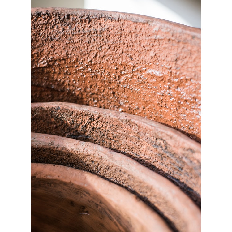 Large terracotta red concrete planter pot with drainage hole, ideal for outdoor gardening.