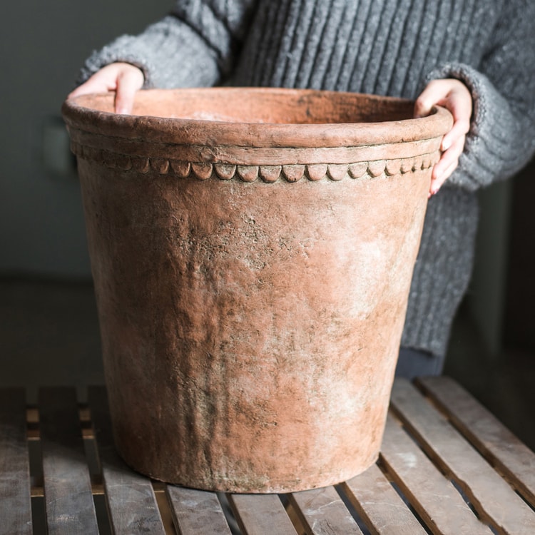 Large terracotta red concrete planter pot with drainage hole, ideal for outdoor gardening.