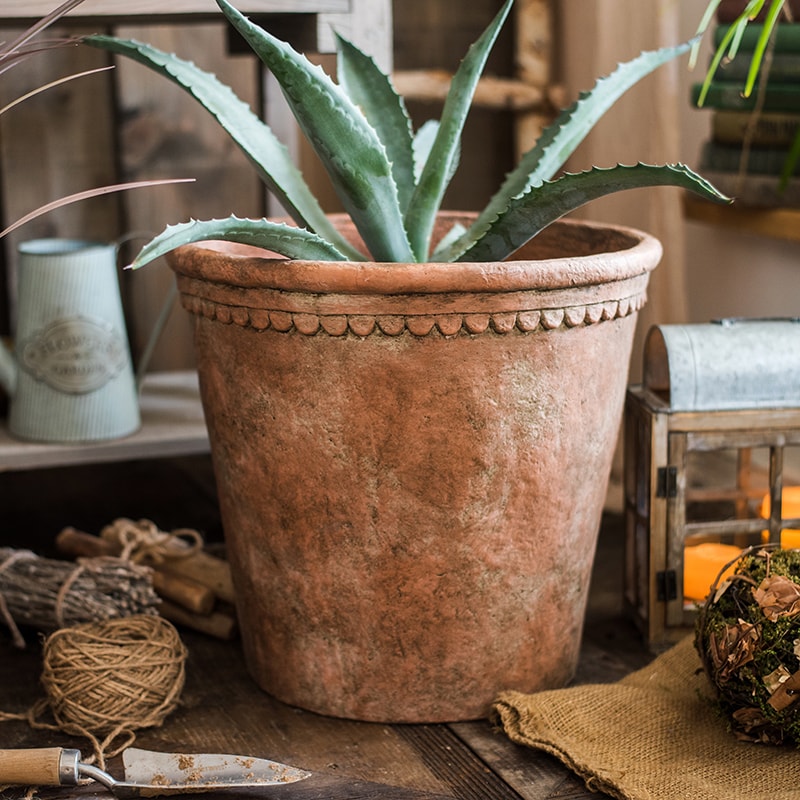 Large terracotta red concrete planter pot with drainage hole, ideal for outdoor gardening.