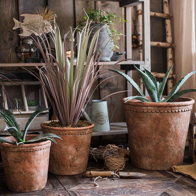 Large terracotta red concrete planter pot with drainage hole, ideal for outdoor gardening.