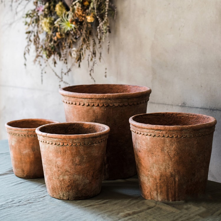 Large terracotta red concrete planter pot with drainage hole, ideal for outdoor gardening.