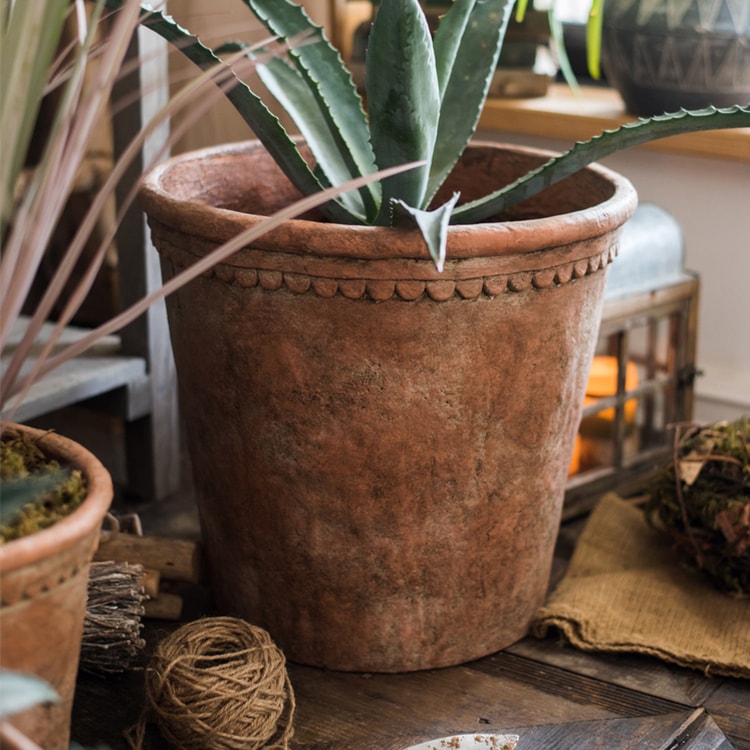 Large terracotta red concrete planter pot with drainage hole, ideal for outdoor gardening.