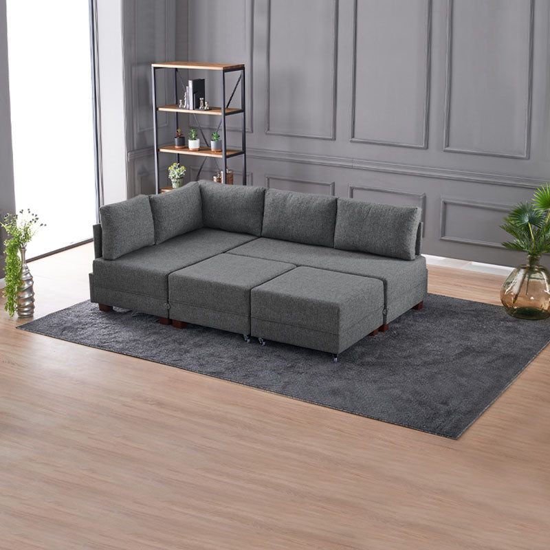 ANDRE Left Corner Sofa/Bed in Charcoal, featuring a modern design with removable trays and stools.