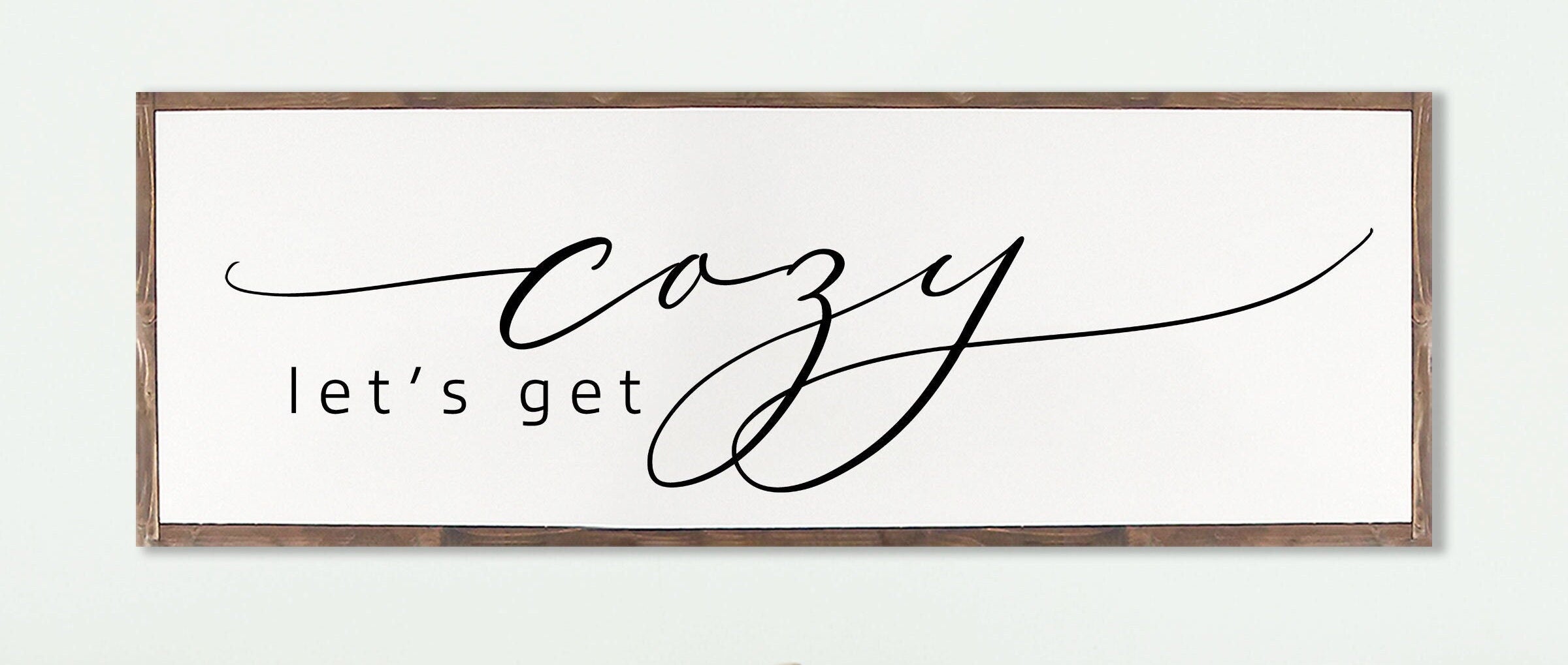 Rustic handmade wood sign featuring the phrase 'Let's Get Cozy', framed and stained in customizable colors, showcasing unique wood grain.