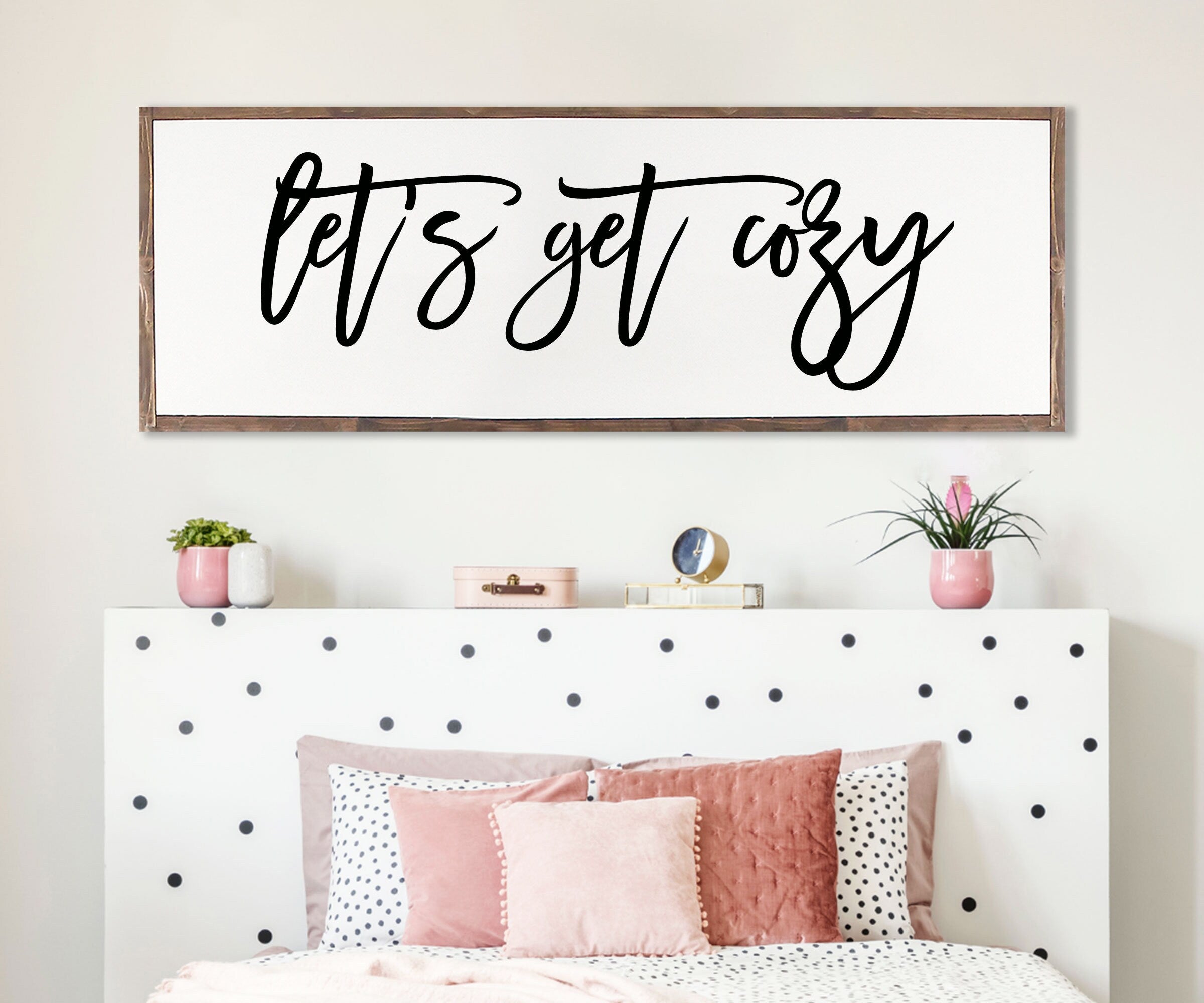 Rustic handmade wood sign with the phrase 'Let's Get Cozy', featuring unique wood grain and customizable frame options.