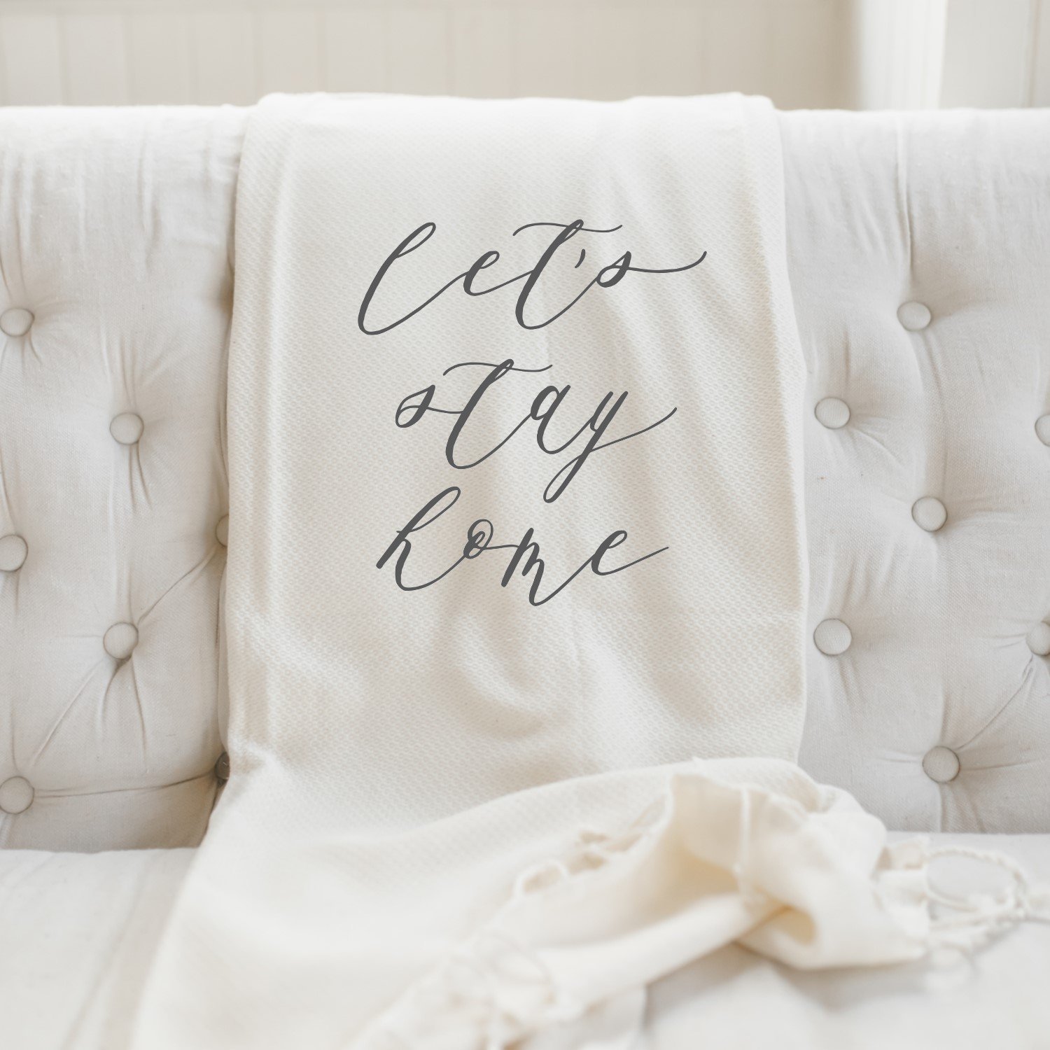 Let's Stay Home Throw Blanket made from 100% organic cotton, featuring a natural color and centered design, perfect for cozy home decor.