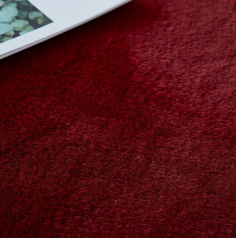 Lily Luxury Red Chinchilla Faux Fur Area Rug showcasing a plush, vibrant red surface with a soft texture, perfect for contemporary living spaces.