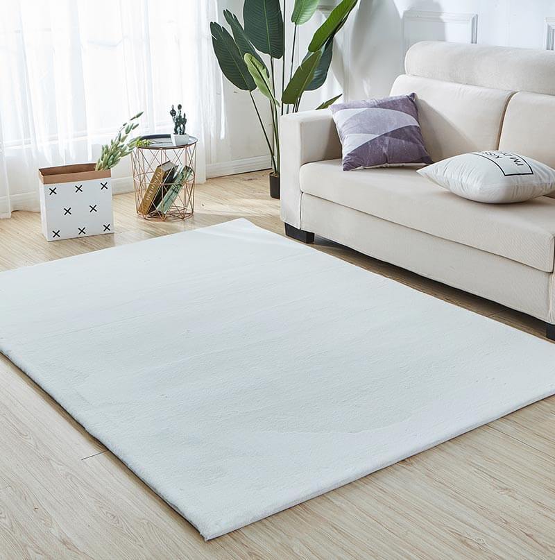 Lily Luxury White Chinchilla Faux Fur Area Rug showcasing a plush, soft texture in a contemporary living space.