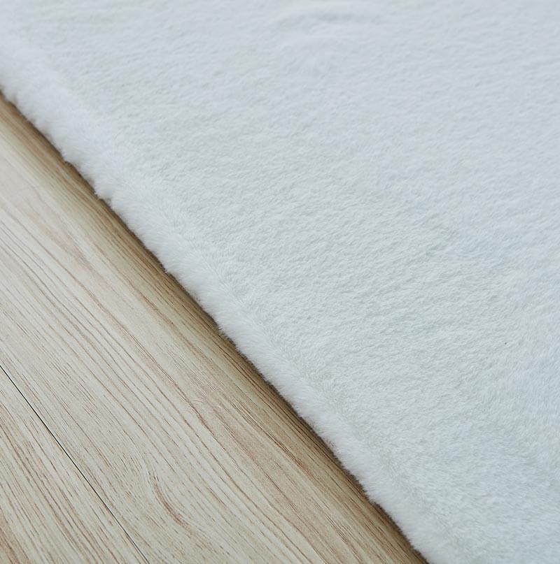 Lily Luxury White Chinchilla Faux Fur Area Rug showcasing a plush, soft texture in a contemporary living space.