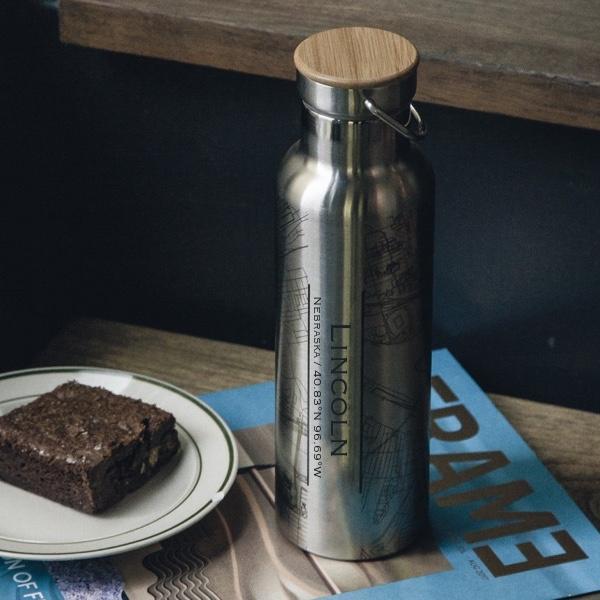 Custom engraved stainless steel bottle featuring a map of Lincoln, Nebraska with a bamboo top, showcasing its unique design.