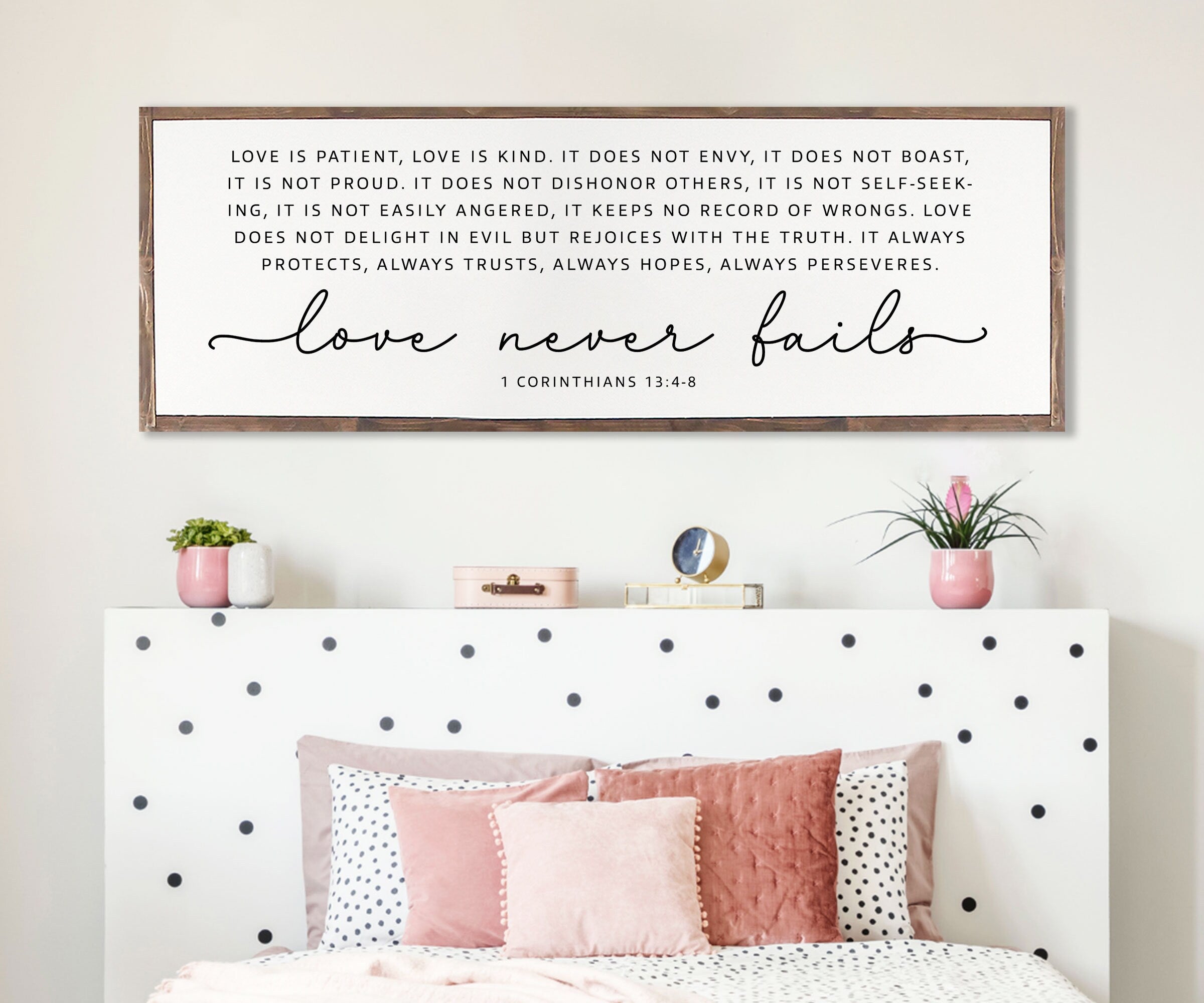 Handmade rustic wood sign featuring the scripture 'Love Never Fails' from 1 Corinthians 13:4-8, framed and customizable in various colors.