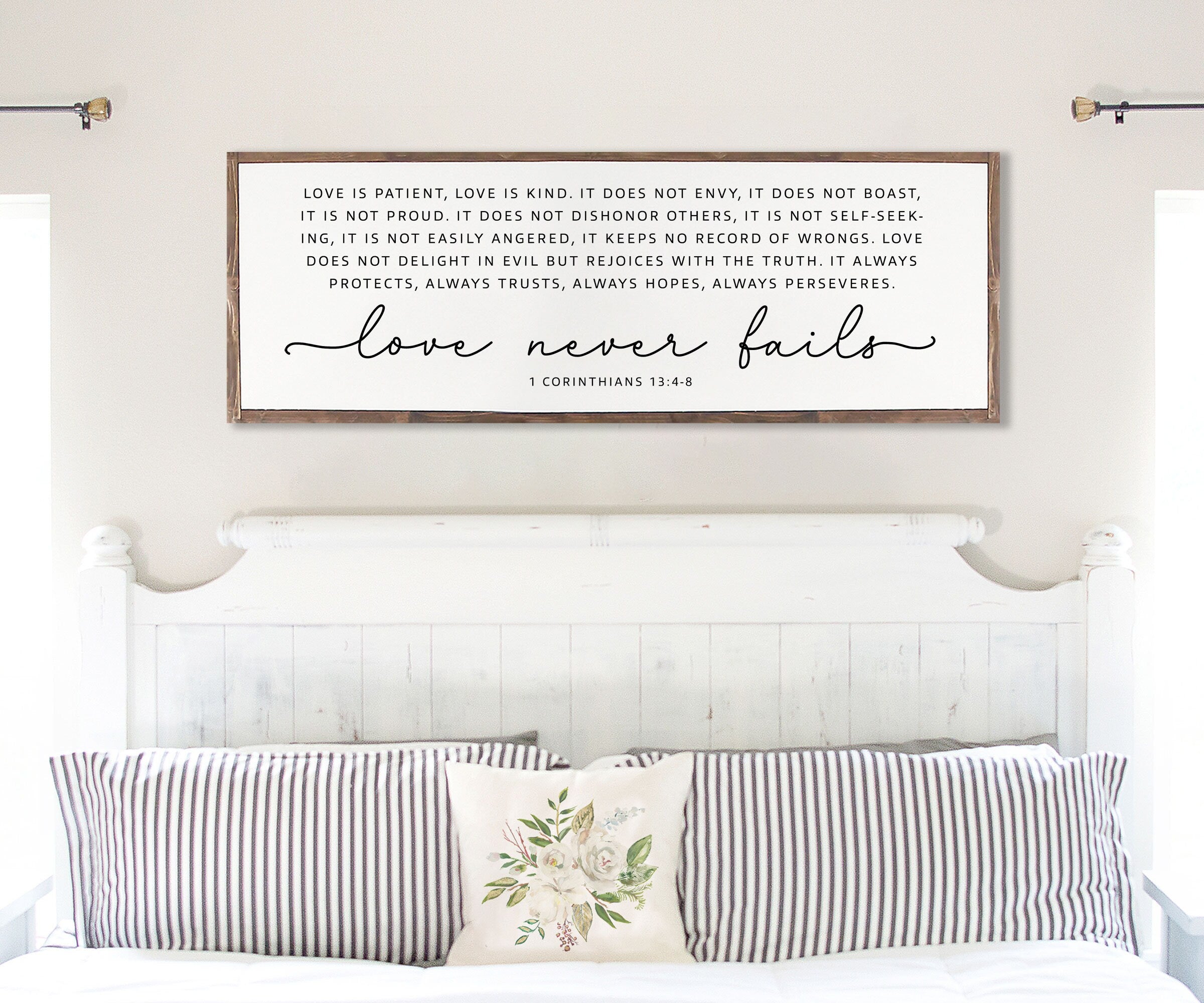 Handmade rustic wood sign featuring the scripture 'Love Never Fails' from 1 Corinthians 13:4-8, framed and customizable in various colors.