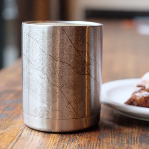 Custom engraved Lubbock Texas map on a stainless steel insulated cup, showcasing coordinates.