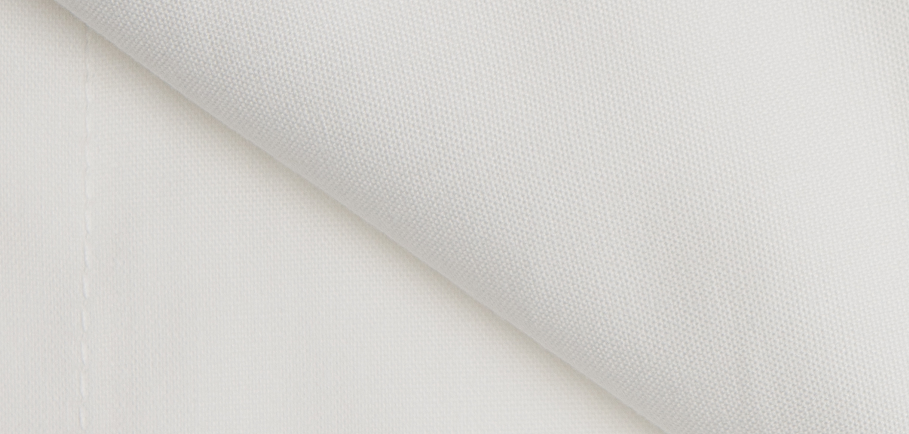 Luxury fitted sheet made from 100% organic cotton, featuring a crisp white color and percale weave for ultimate comfort.