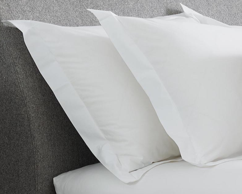 Luxury organic cotton pillow case in white, showcasing its soft texture and breathable percale weave, perfect for a comfortable night's sleep.