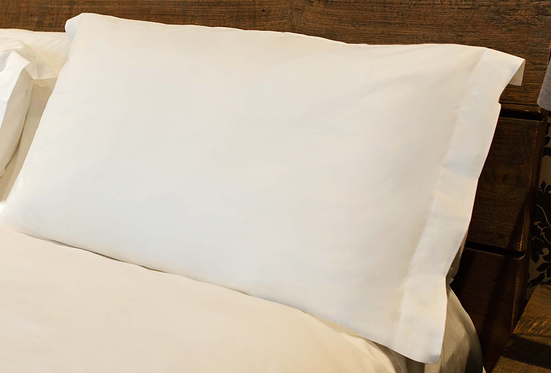 Luxury organic cotton pillow case in white, showcasing its soft texture and breathable percale weave, perfect for a comfortable night's sleep.