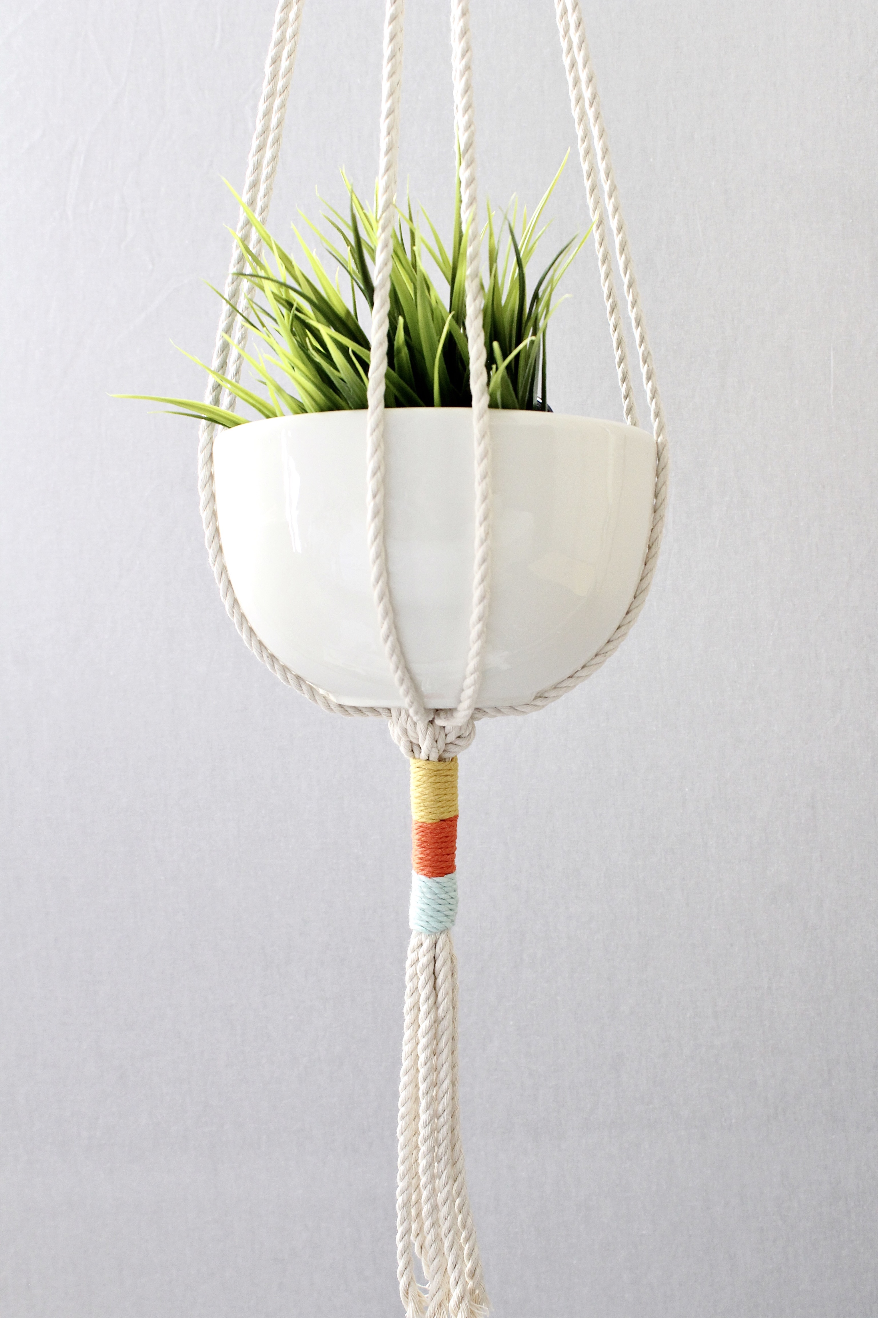 Color Block Macrame Plant Hanger made from natural cotton rope, showcasing a stylish design for indoor plants.