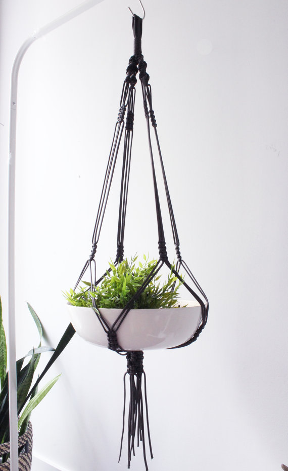 Handmade macrame plant hanger made of durable nylon cord, showcasing a beautiful design with intricate knots, perfect for displaying various pot sizes.