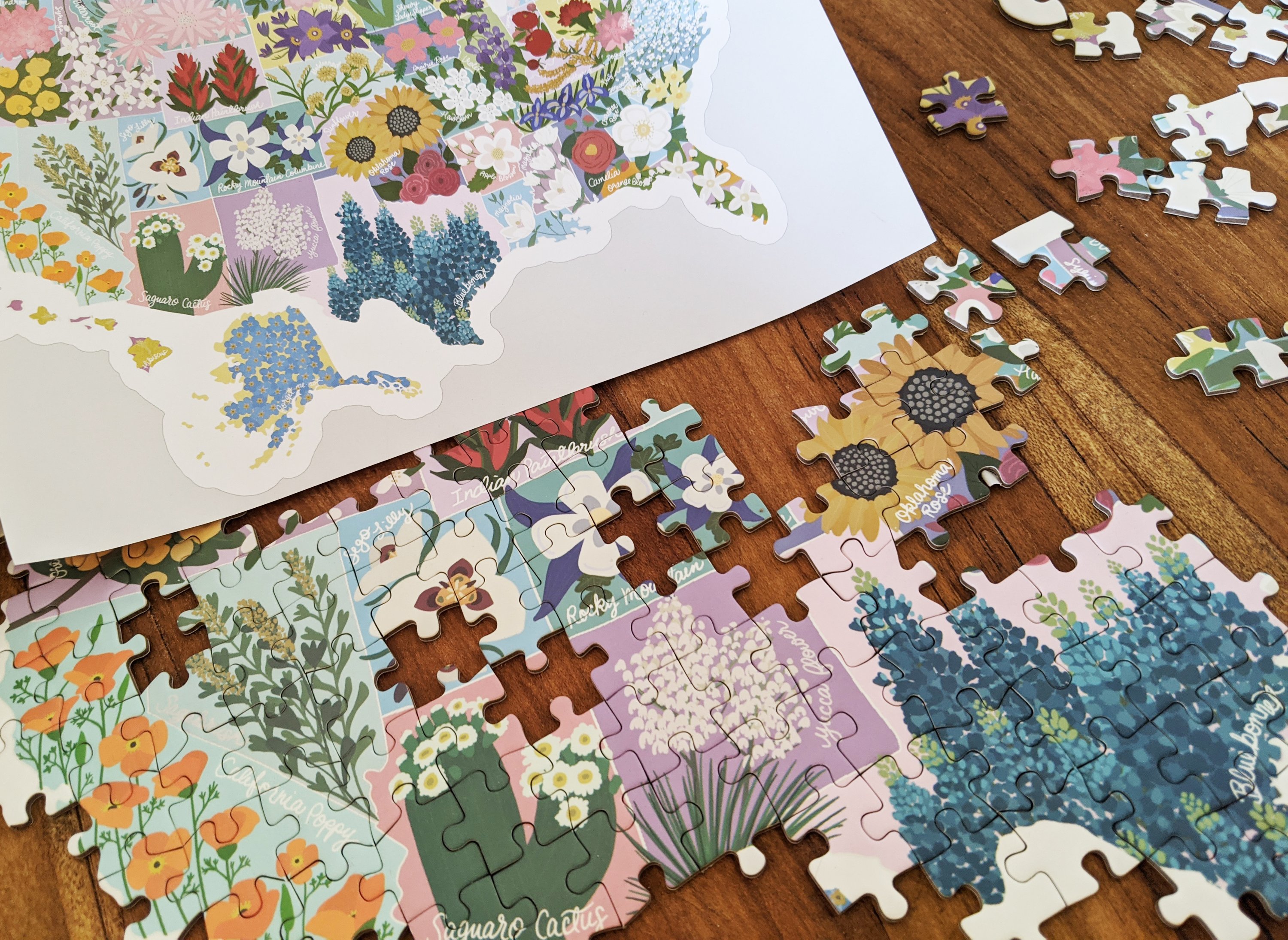 Map shaped jigsaw puzzle featuring US state flowers, colorful and detailed design with unique pieces.