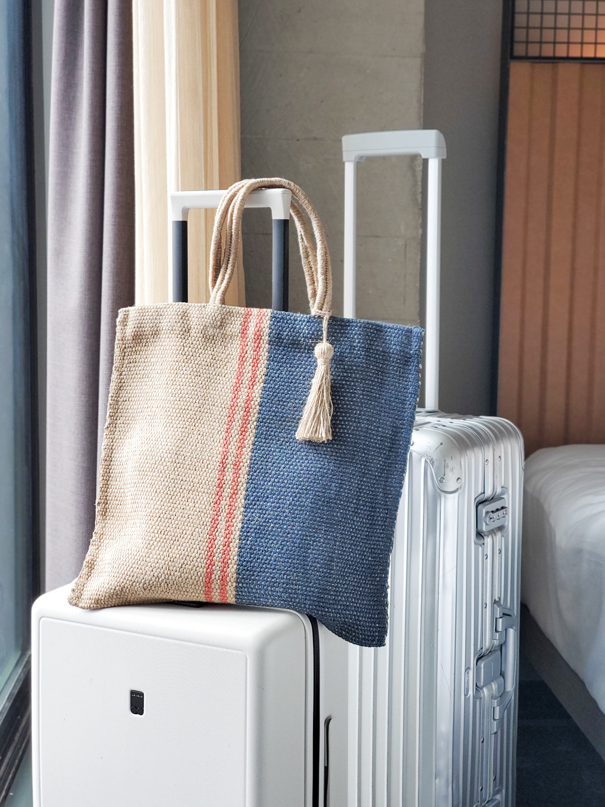 Maya Jute Tote Bag in natural, navy, and red colors, showcasing its handwoven texture and spacious design.