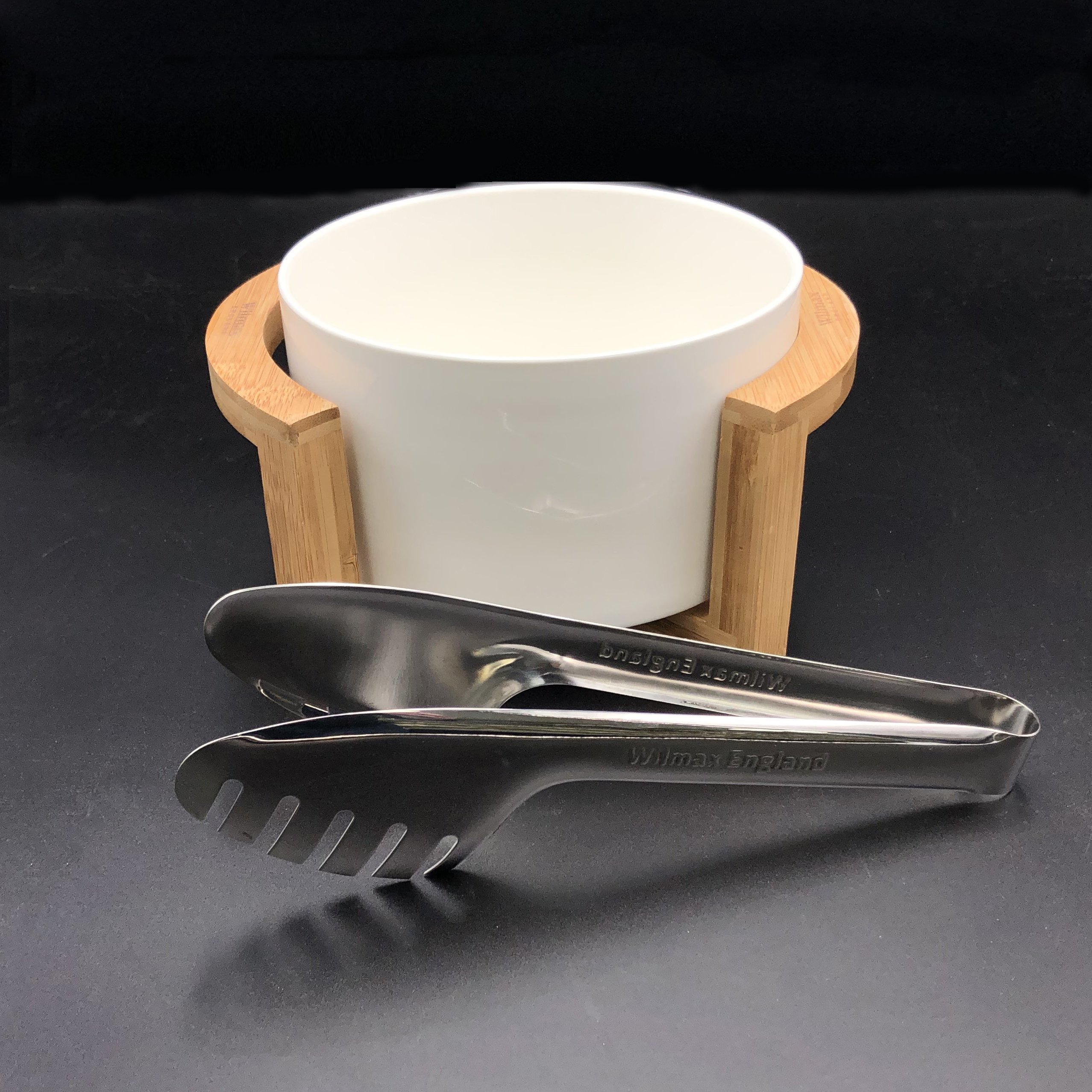 Medium salad bowl set featuring a fine porcelain bowl, stainless steel serving tongs, and a bamboo stand for elegant dining.