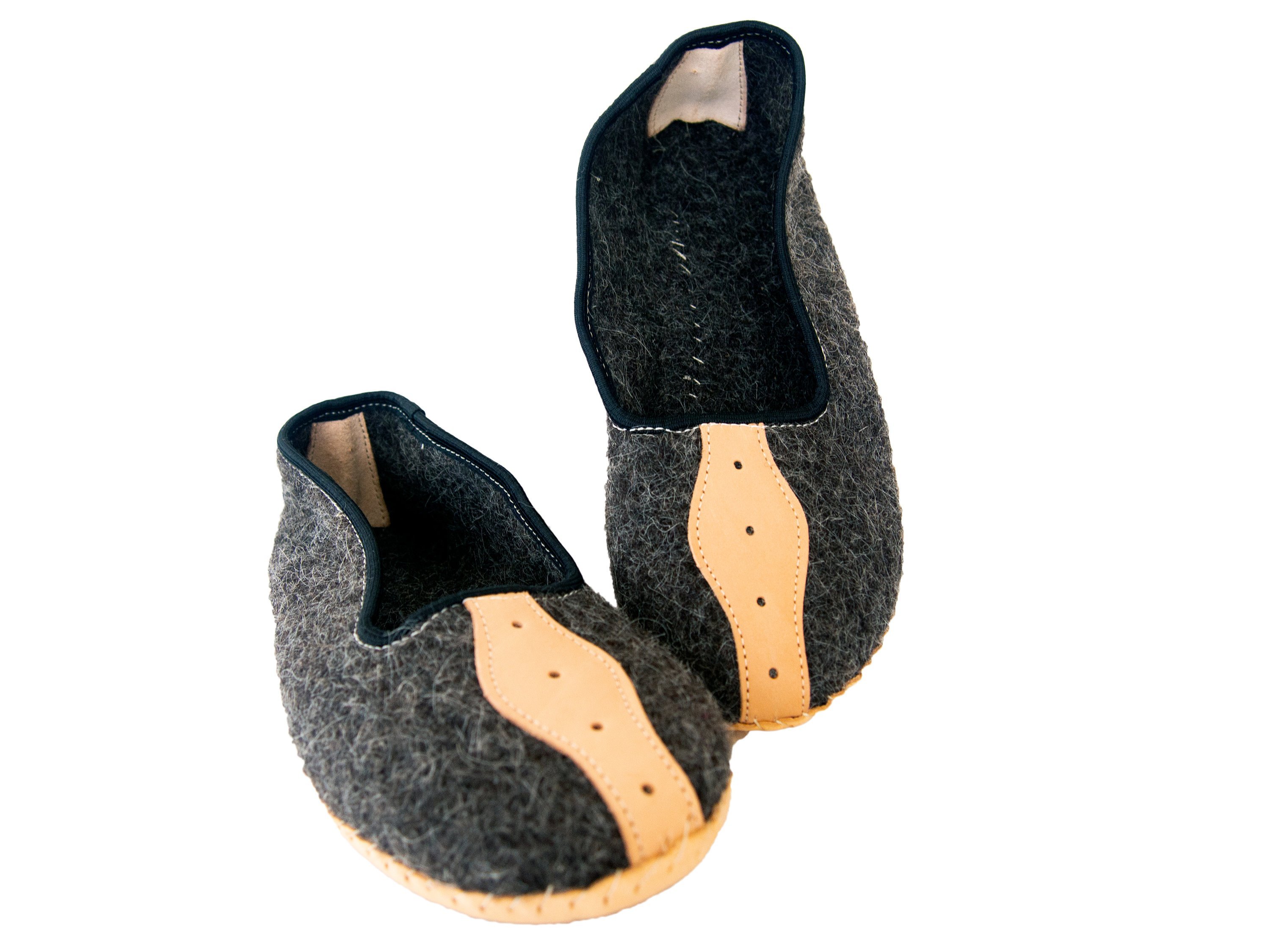 A pair of elegant mens slippers made from felt and genuine leather, showcasing their handcrafted quality and stylish design.