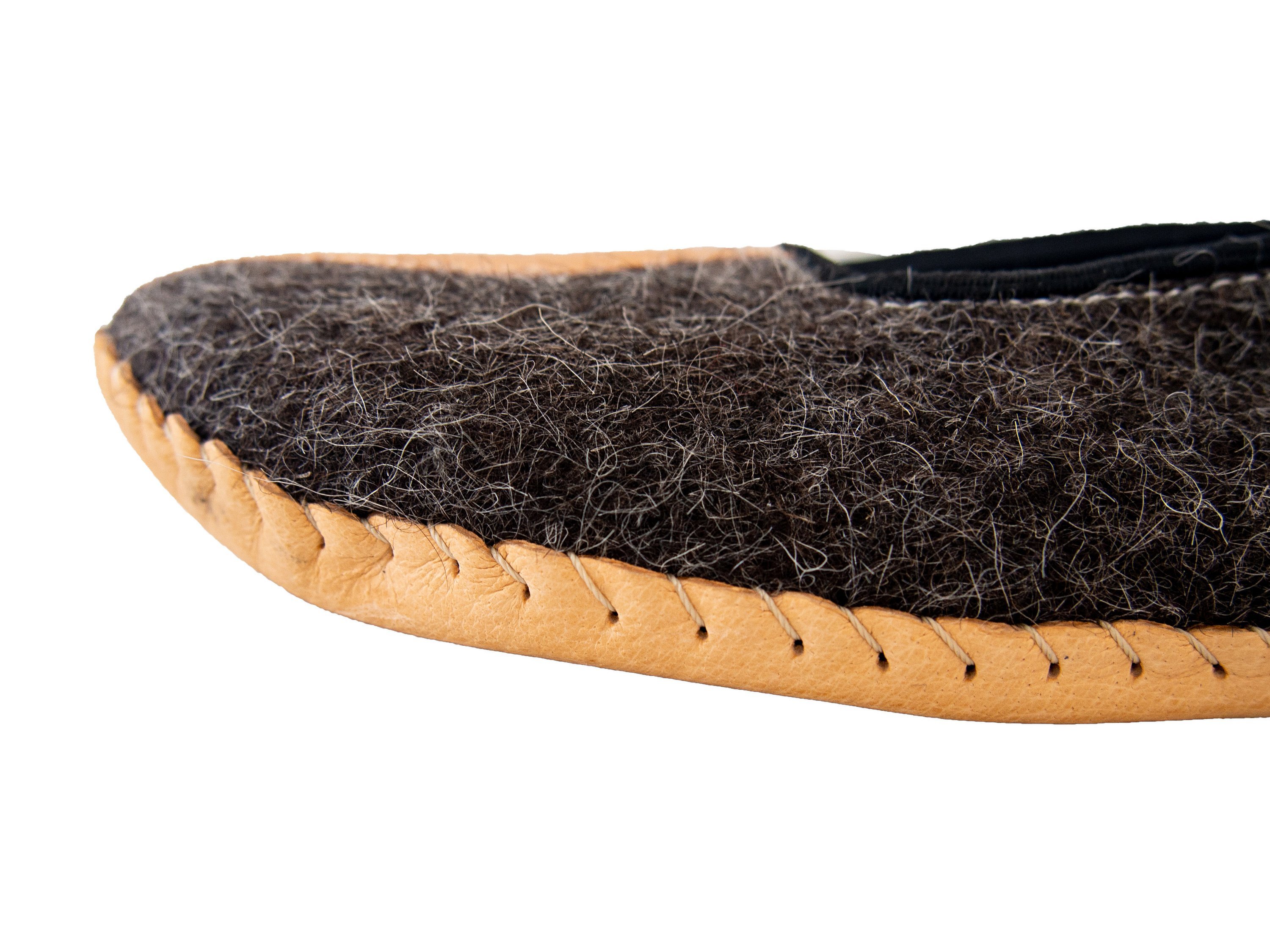 A pair of elegant mens slippers made from felt and genuine leather, showcasing their handcrafted quality and stylish design.