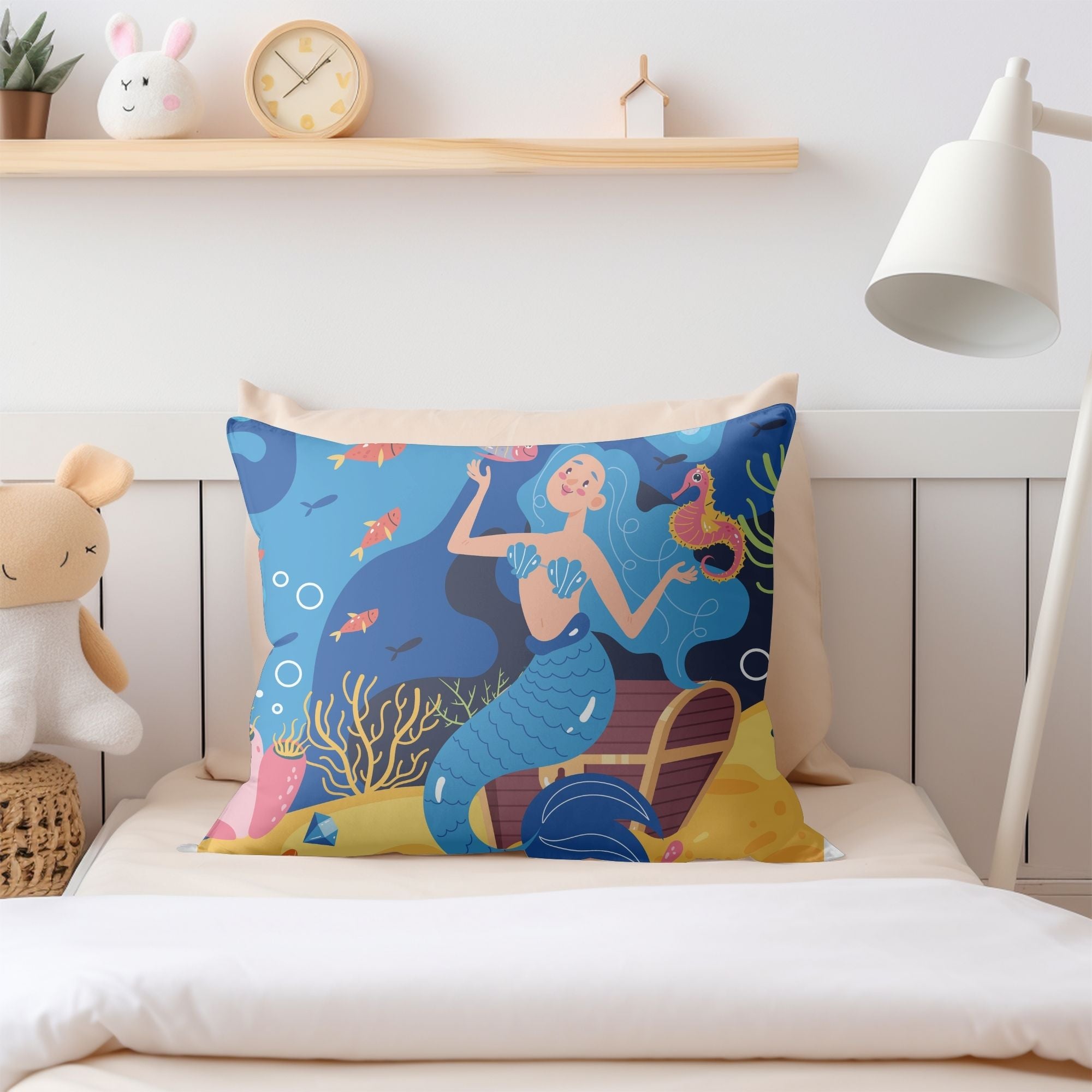 A colorful pillow featuring a vibrant mermaid pattern, perfect for girls' rooms, with a light cream back.