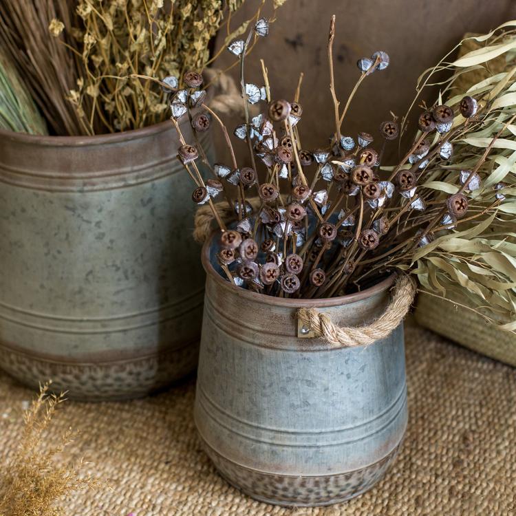 Metal flower pail with rope handles in gray and rusty colors, perfect for decorative floral arrangements.