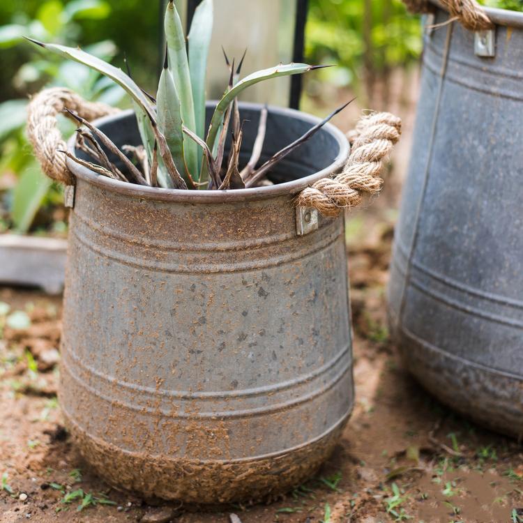 Metal flower pail with rope handles in gray and rusty colors, perfect for decorative floral arrangements.