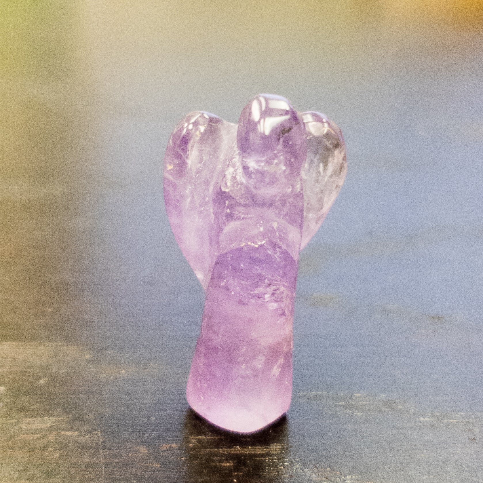 A collection of Mini Angel Carvings made from Angelite, Fluorite, Amethyst, Quartz, and Rose Quartz, showcasing their intricate details and vibrant colors.