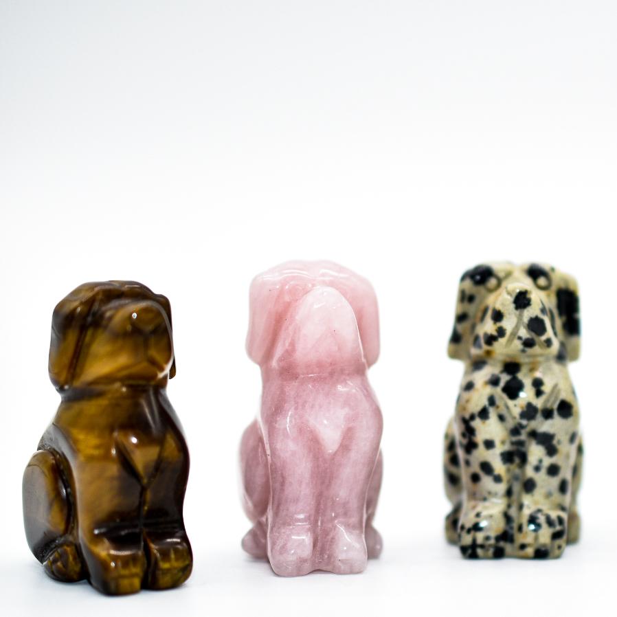 A collection of Mini Crystal Carved Dogs made from various gemstones, showcasing different breeds and sizes.