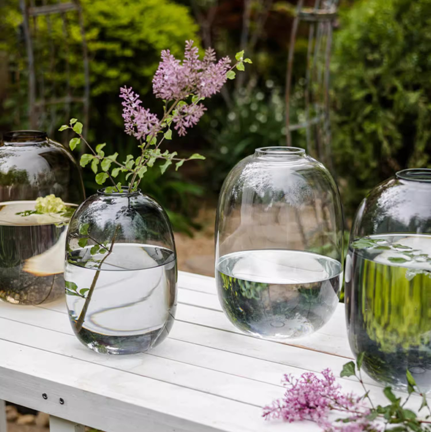 A modern clear glass vase in gray and yellow options, showcasing its elegant hand-blown design and perfect for floral arrangements.