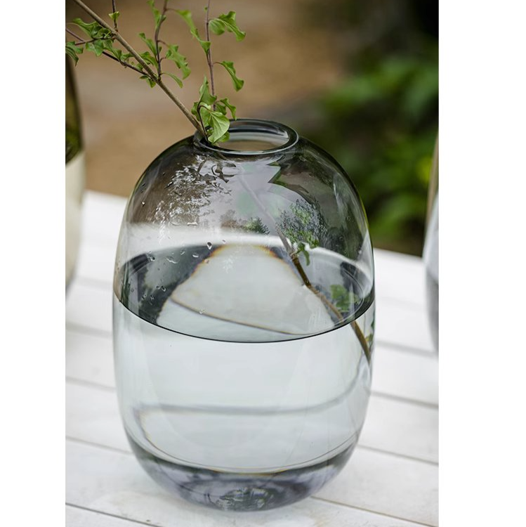 A modern clear glass vase in gray and yellow options, showcasing its elegant hand-blown design and perfect for floral arrangements.