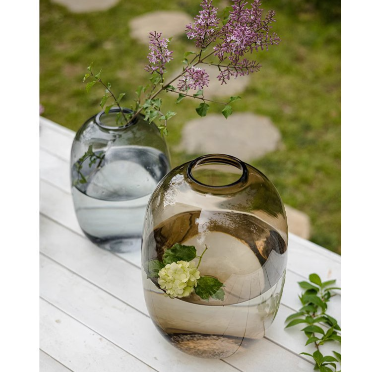 A modern clear glass vase in gray and yellow options, showcasing its elegant hand-blown design and perfect for floral arrangements.