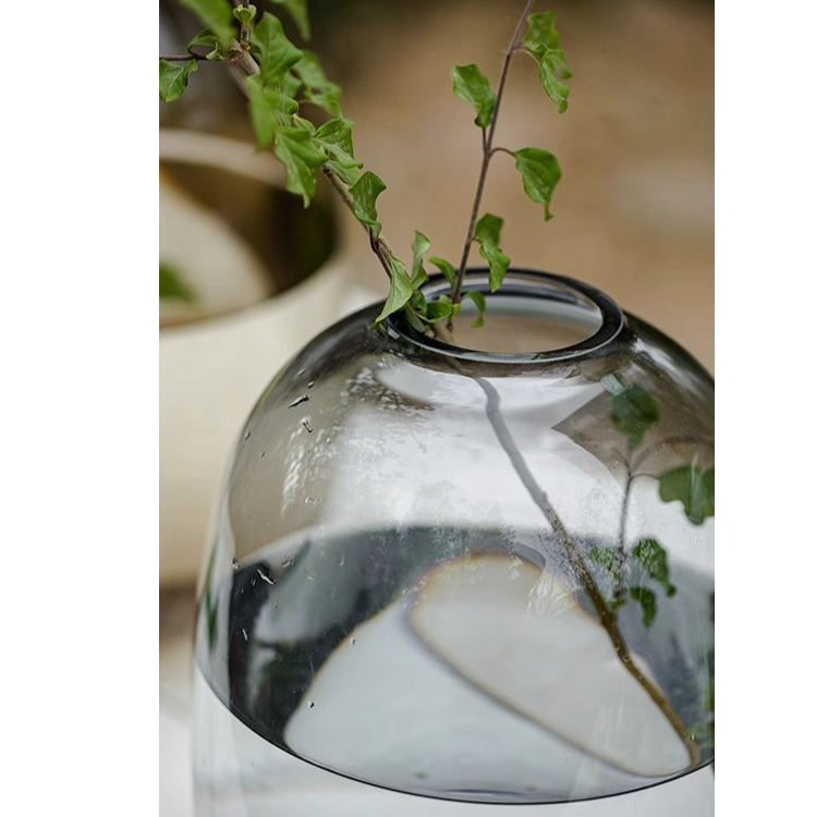 A modern clear glass vase in gray and yellow options, showcasing its elegant hand-blown design and perfect for floral arrangements.