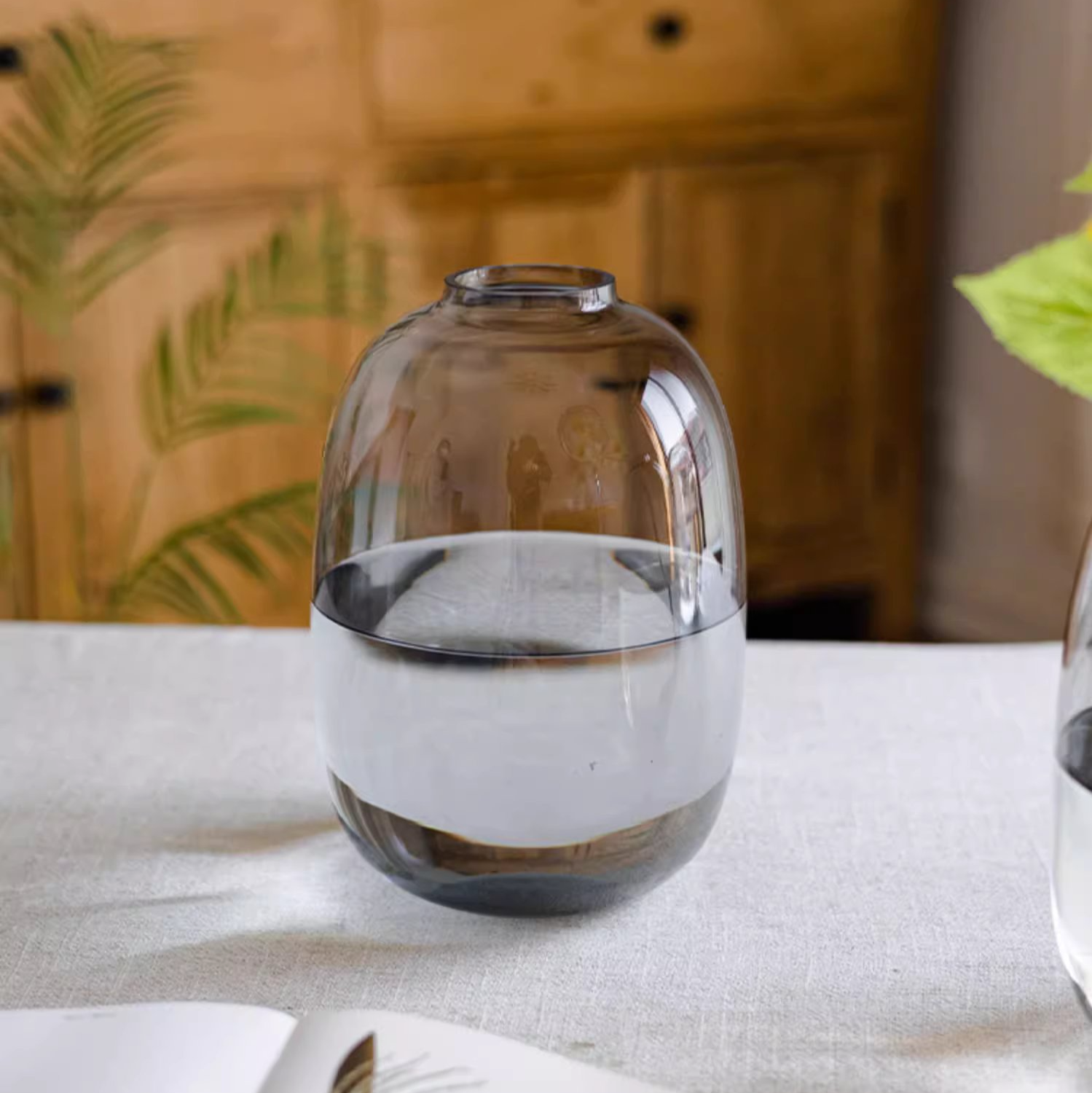 A modern clear glass vase in gray and yellow options, showcasing its elegant hand-blown design and perfect for floral arrangements.