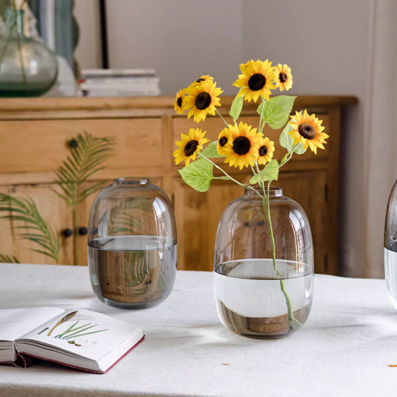 A modern clear glass vase in gray and yellow options, showcasing its elegant hand-blown design and perfect for floral arrangements.