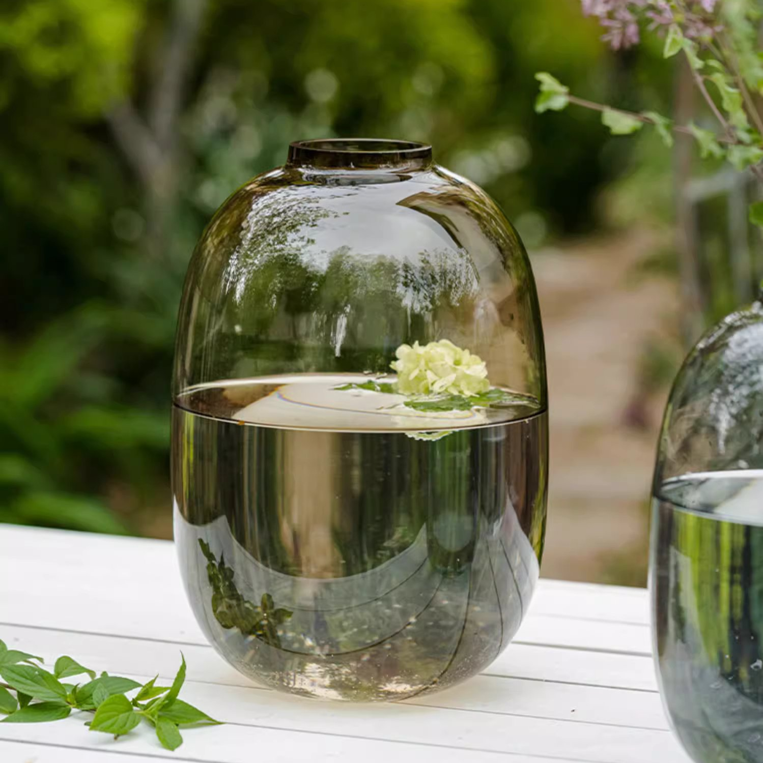 A modern clear glass vase in gray and yellow options, showcasing its elegant hand-blown design and perfect for floral arrangements.