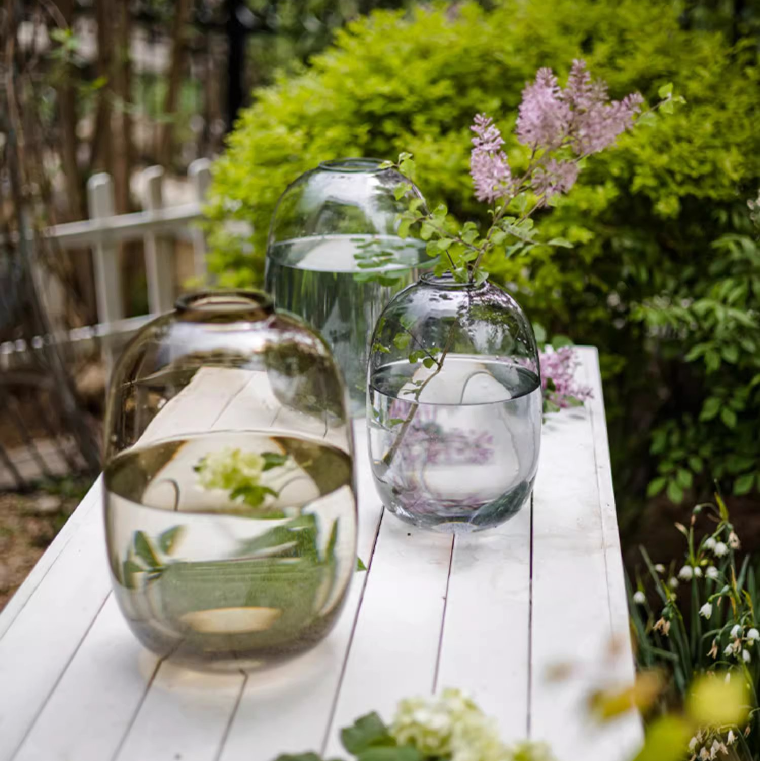 A modern clear glass vase in gray and yellow options, showcasing its elegant hand-blown design and perfect for floral arrangements.