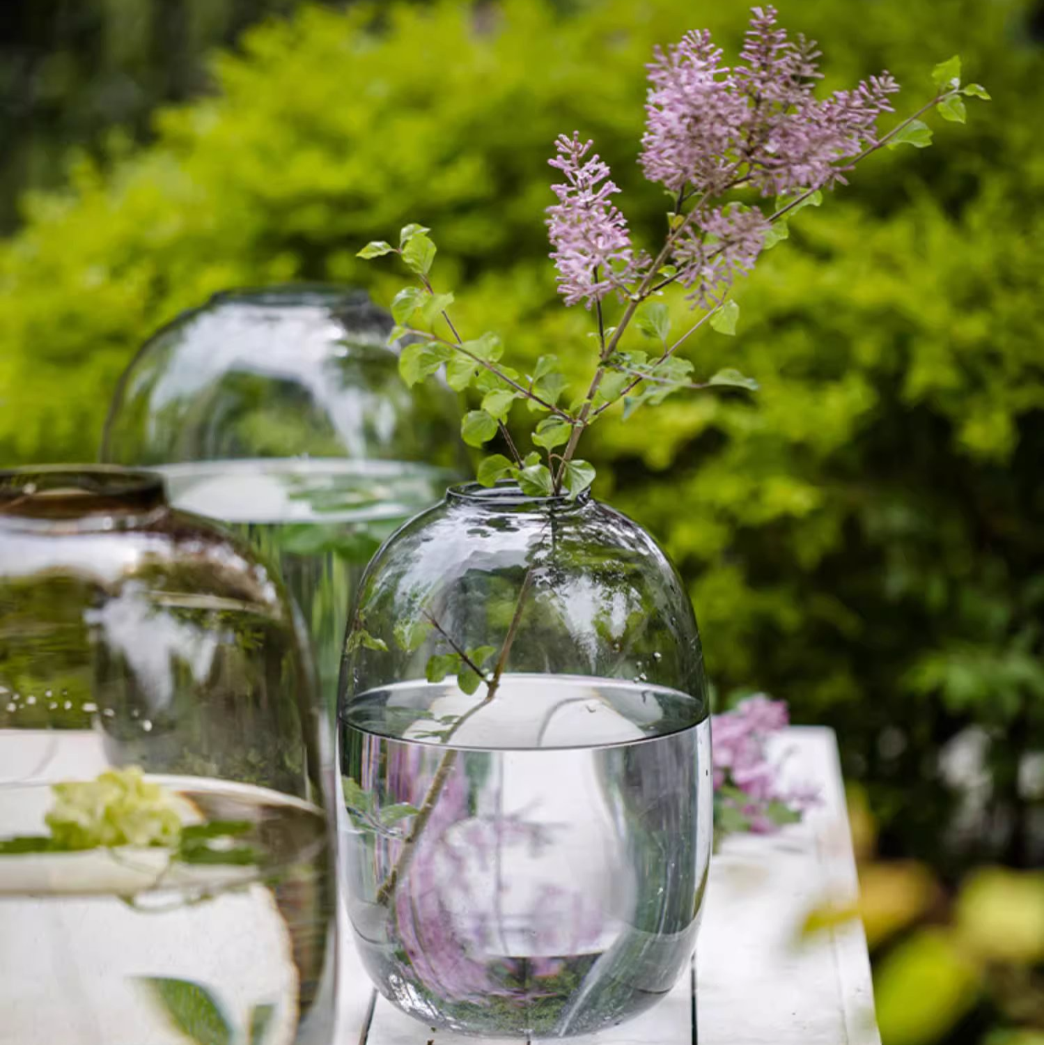 A modern clear glass vase in gray and yellow options, showcasing its elegant hand-blown design and perfect for floral arrangements.